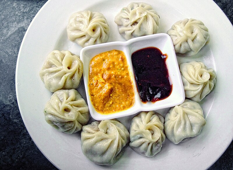 Tandoori Momos with smoky char marks and creamy sauce 