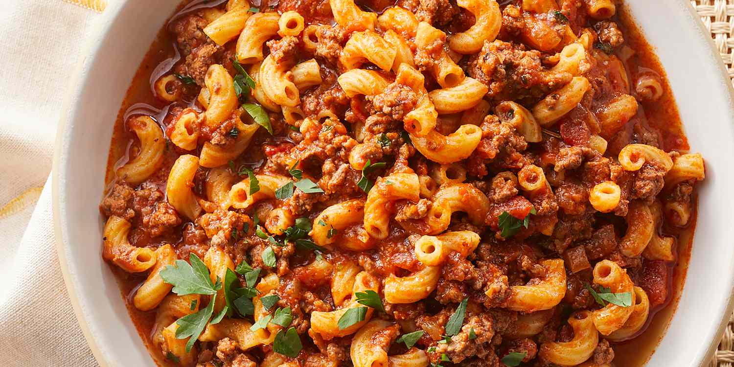 Goulash served with dumplings and fresh herbs on a rustic plate 