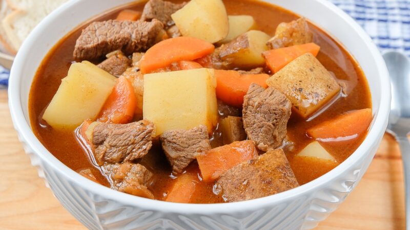 A steaming bowl of traditional Hungarian Goulash with paprika