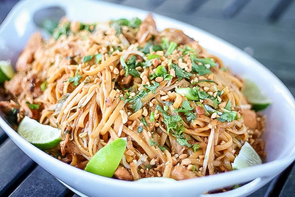 Spicy Pad Thai topped with chili flakes and a fried egg 